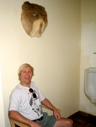 Of course this is in Key West.  What is that thing above Kurtis?  Why is there a chair in the guy's bathroom?  If you guessed right, it is the butt of burrow with eyes glued on.  No idea why the chair faces the urinal...